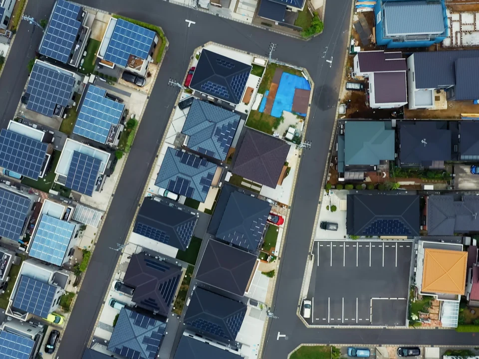 Birds eye view of solar panels, buildings, roads, all of which must be managed with a high degree of asset management maturity.